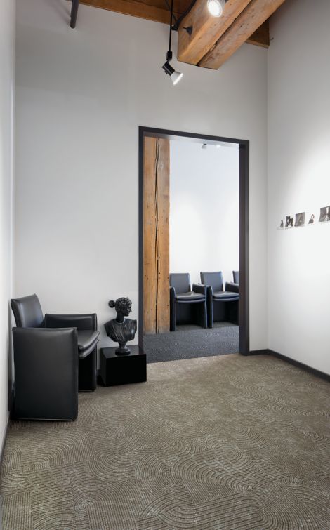 Interface Walk About LVT and Step This Way carpet tile in waiting area with leather chair