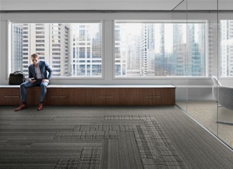 Interface Stitchery, Plain Stitch, and Stitch Count plank carpet tile in lobby area with man sitting on bench