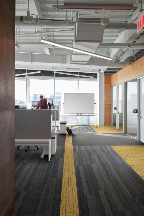 Interface Plain Stitch and Circuit Board plank carpet tile in office area with man working at computer imagen número 2