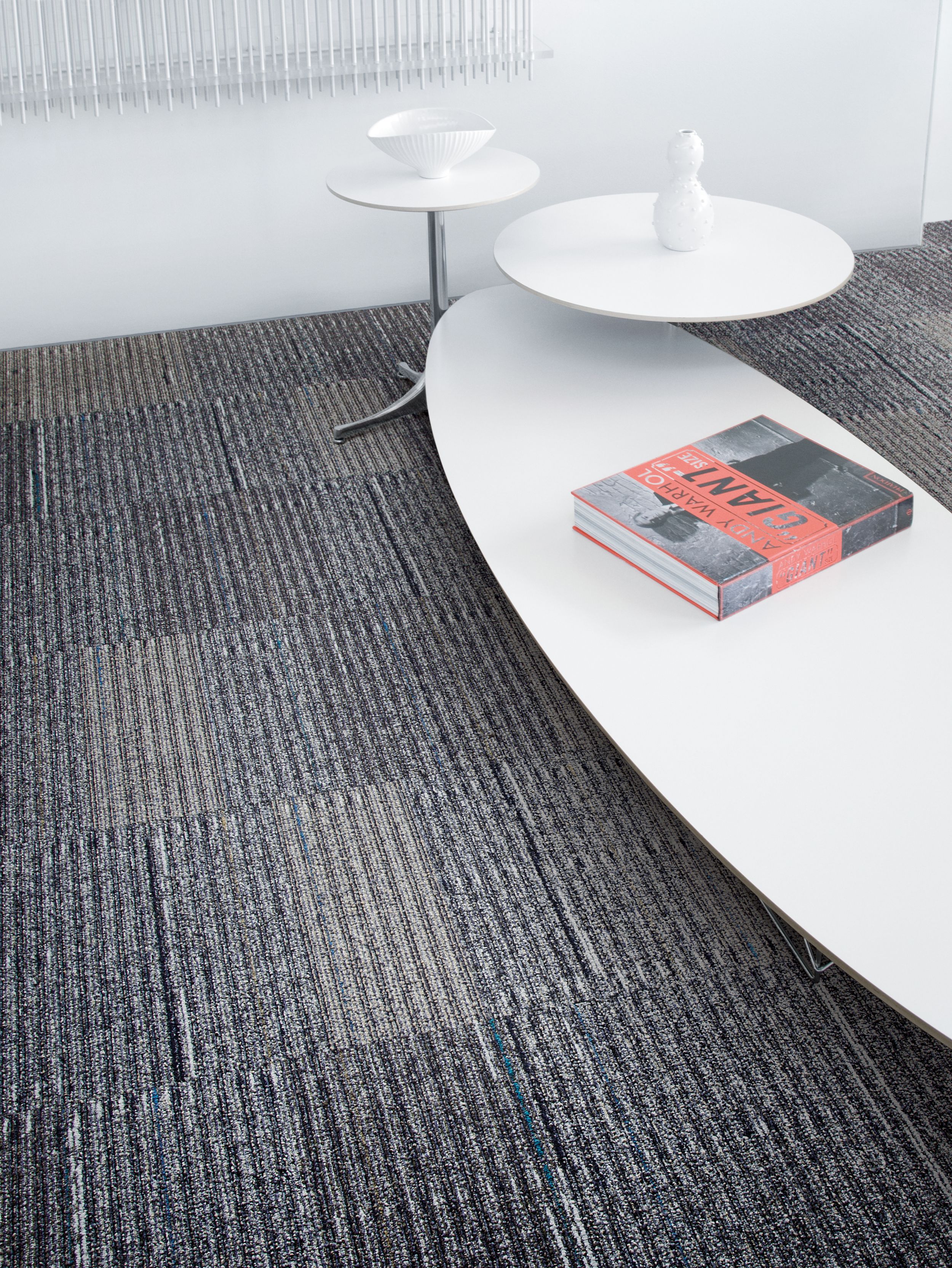 Detail of Interface Stroud II carpet tile with white tables of varying sizes image number 7