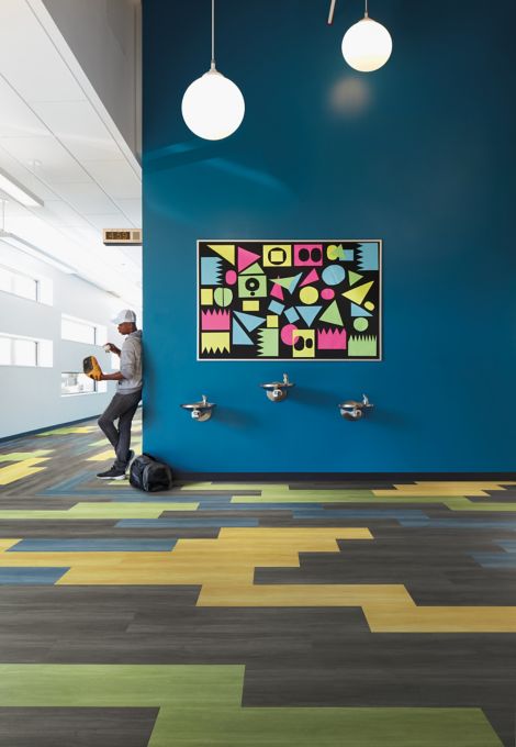 Interface Studio Set LVT in school common area with art and water fountains