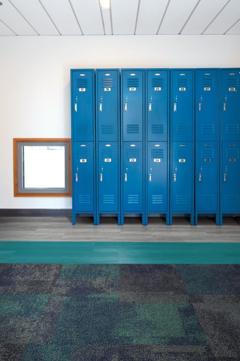 Interface Exposed carpet tile and Studio Set LVT in hallway with blue lockers