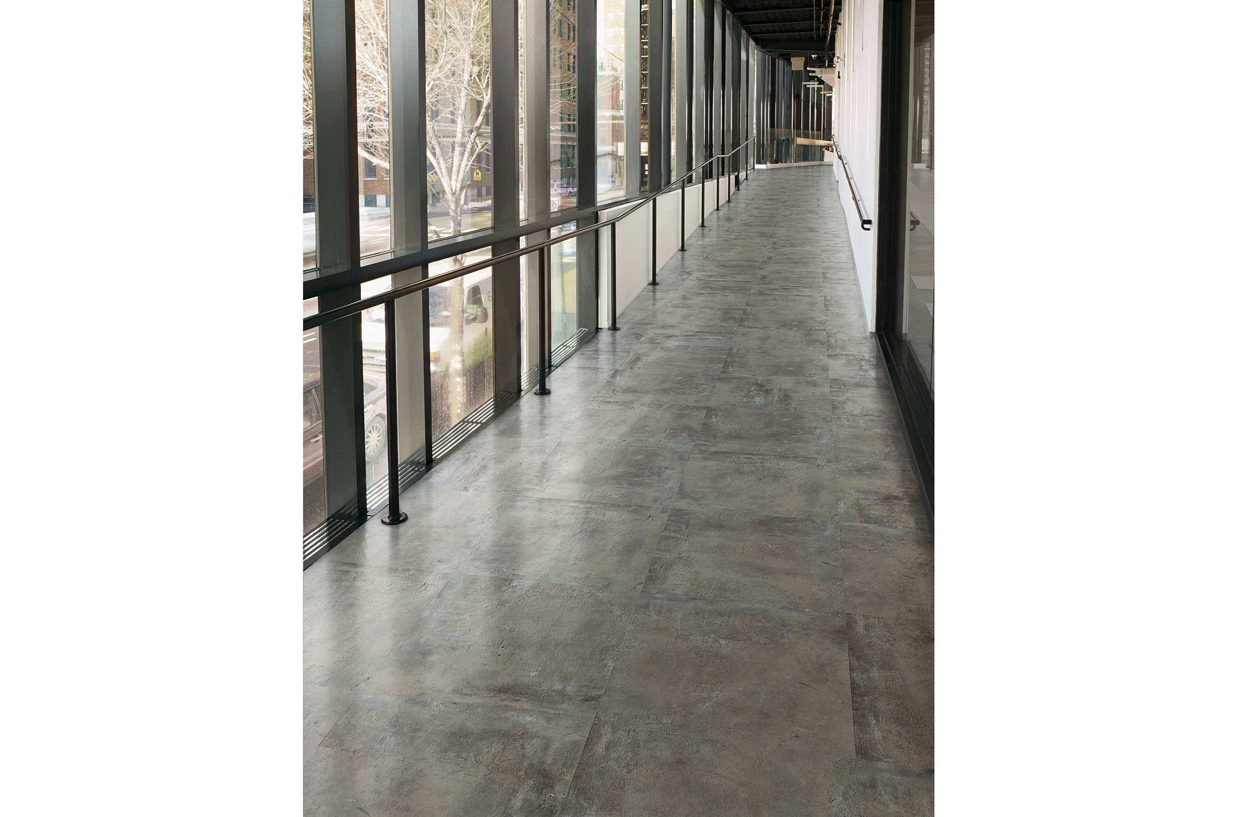 Interface Textured Stones LVT in corridor with railing image number 1