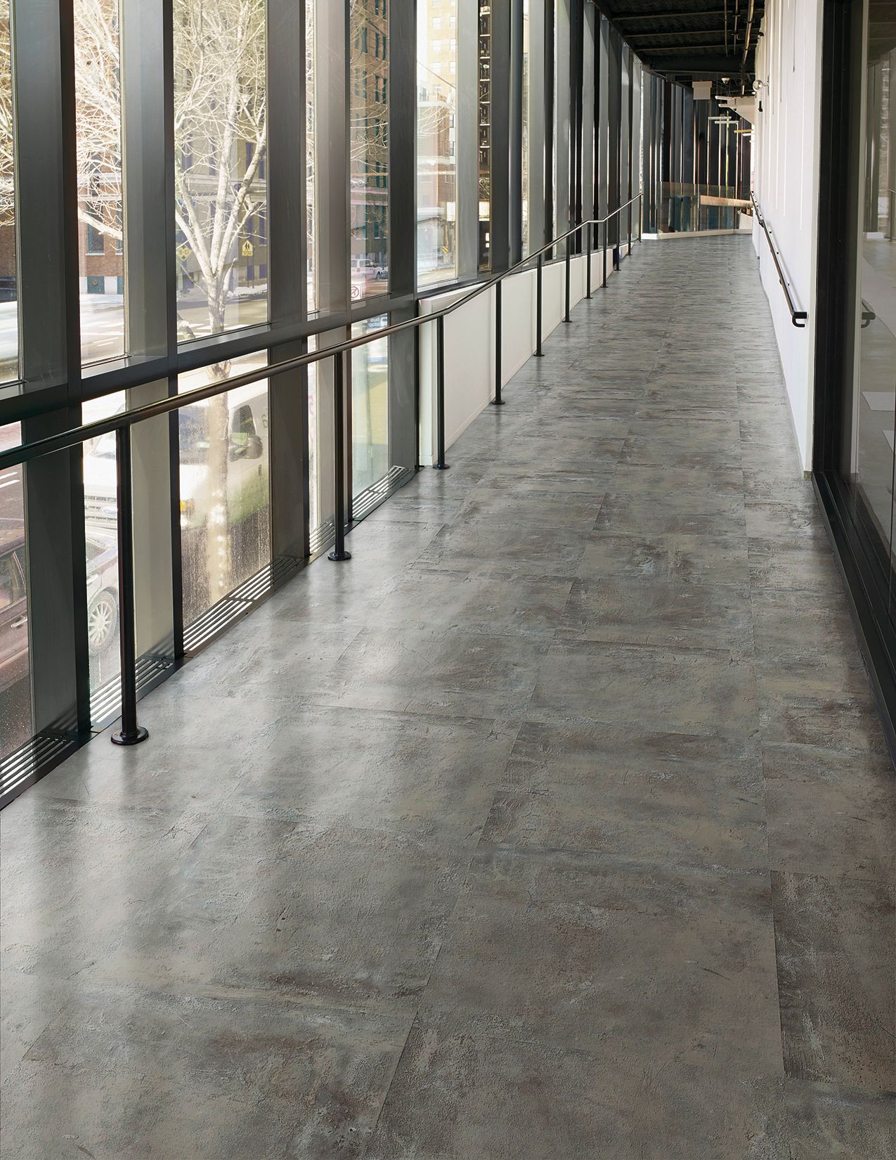 Interface Textured Stones LVT in corridor with railing imagen número 1