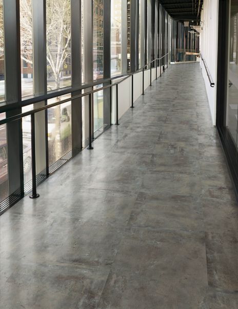 Interface Textured Stones LVT in corridor with railing