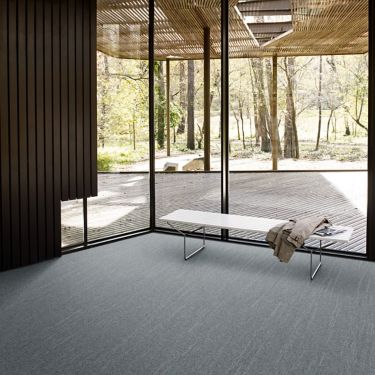 Interface Tide Pool Ripple carpet tile in open room with bench and jacket imagen número 1