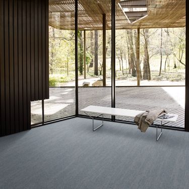 Interface Tide Pool Wave carpet tile in open room with bench and jacket imagen número 1