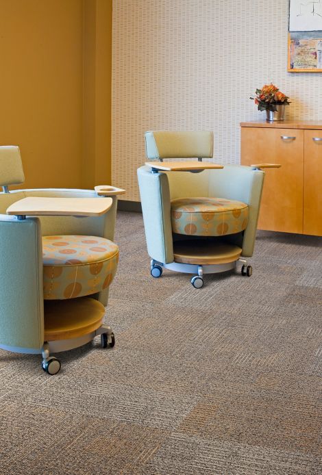 Interface carpet tile in room with wheeled chairs with trays