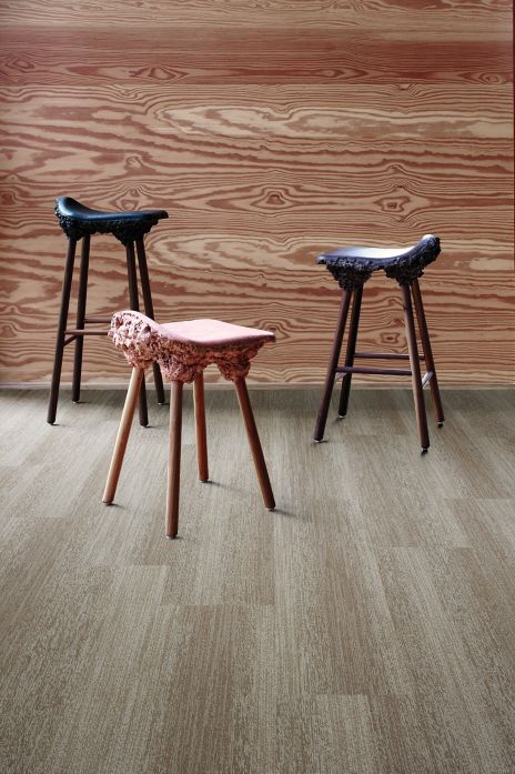 Interface Touch of Timber plank carpet tile in room with plywood wall and three unusual stools
