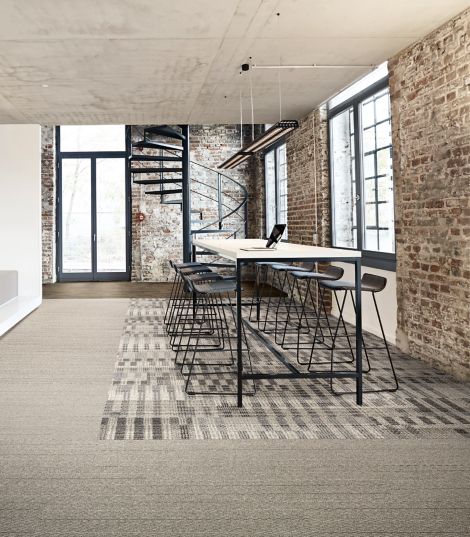 Interface Loom of Life and Tangled & Taut plank carpet tile with Textured Woodgrains LVT in seating area with brick walls and spiral staircase in background imagen número 3