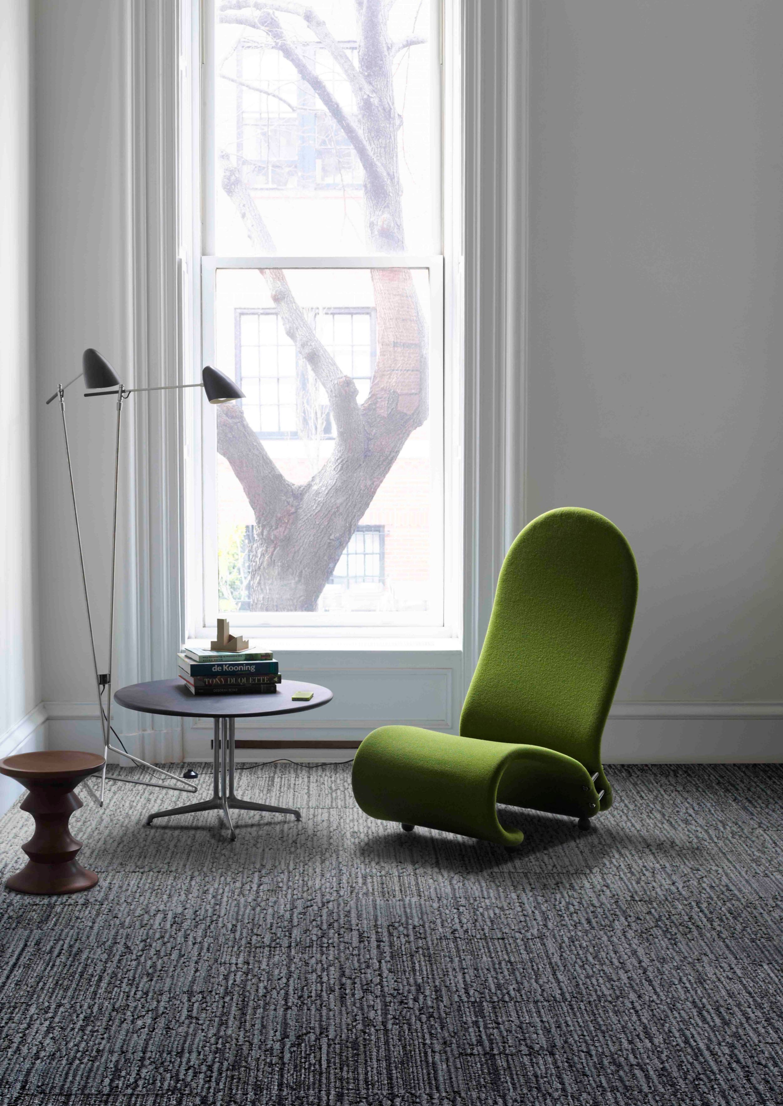 Interface UR201 carpet tile in room with green chair, round table and Eames stool with tall window image number 2