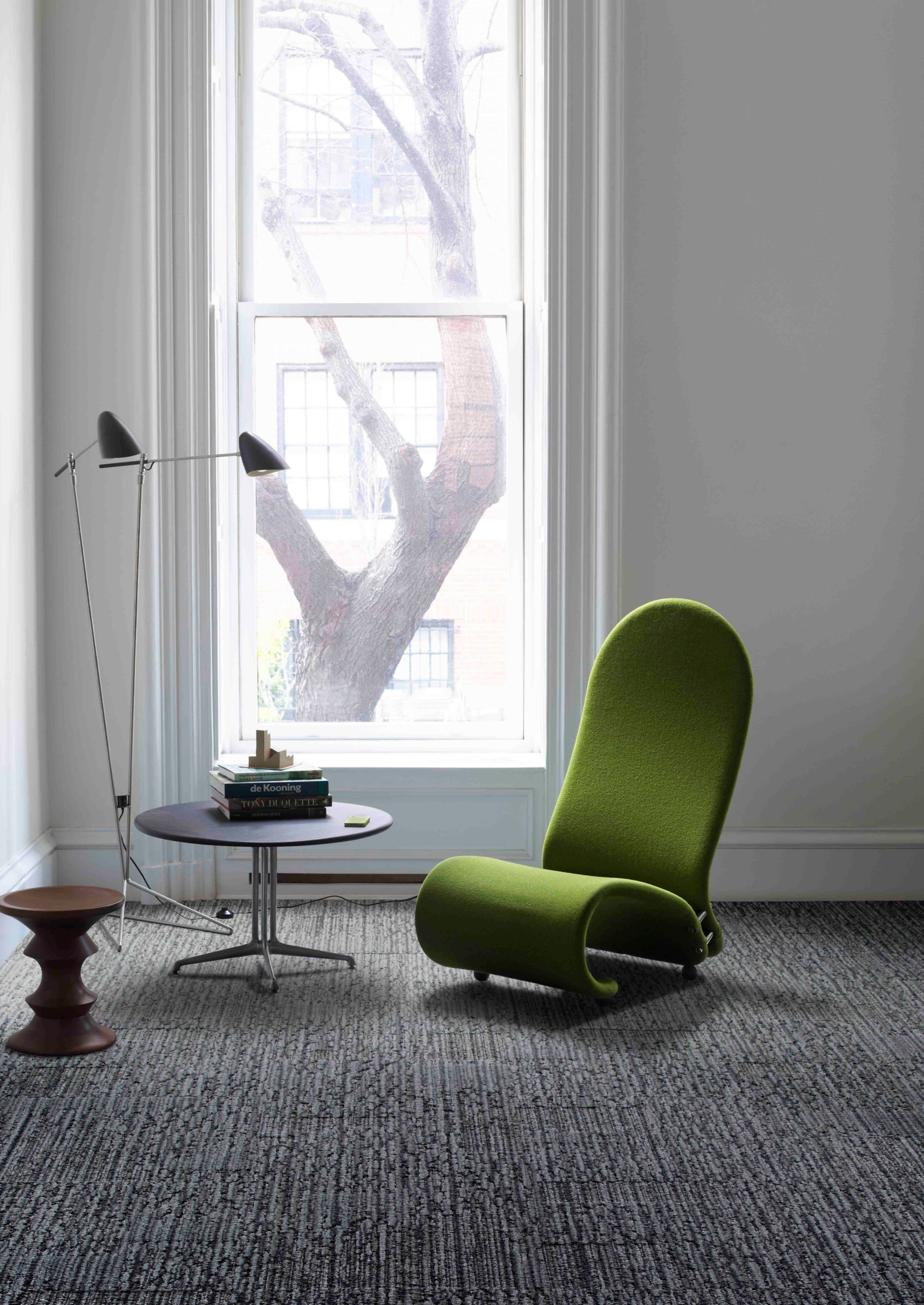 Interface UR201 carpet tile in room with green chair, round table and Eames stool with tall window image number 6