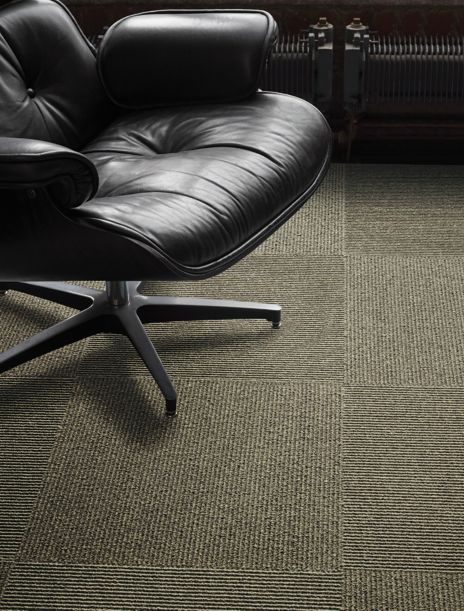 Interface UR203 carpet tile in a close up with leather chair