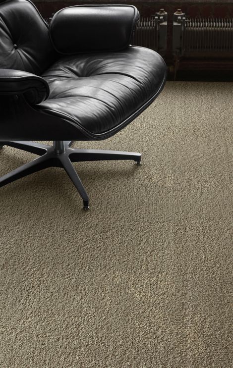 Interface UR301 carpet tile in a close up with leather chair