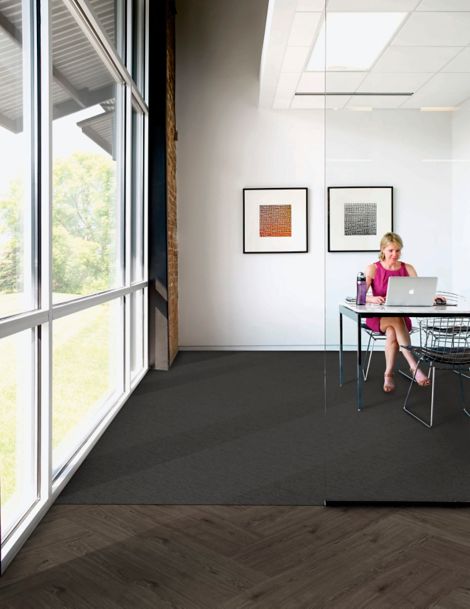 Interface UR303 carpet tile in private office with woman at computer and Natural Woodgrains LVT in outer office image number 4