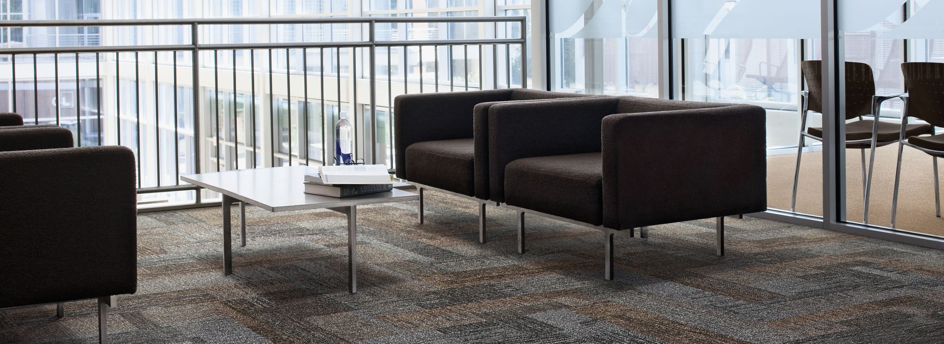 Interface Verticals plank carpet tile in seating area with two couches and glass table