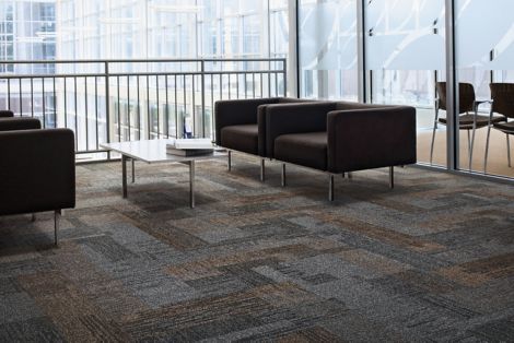 Interface Verticals plank carpet tile in seating area with two couches and glass table