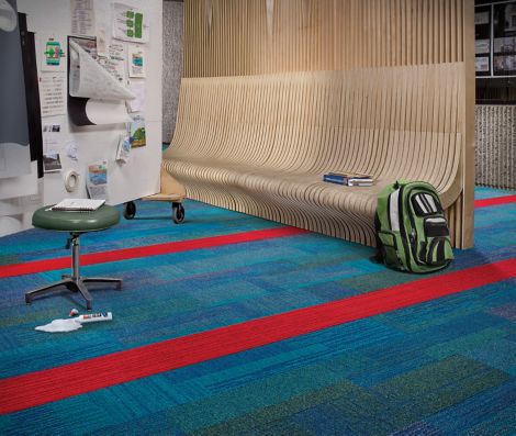 Interface Verticals and On Line plank carpet tile in seating area with wood bench, stool and backpack