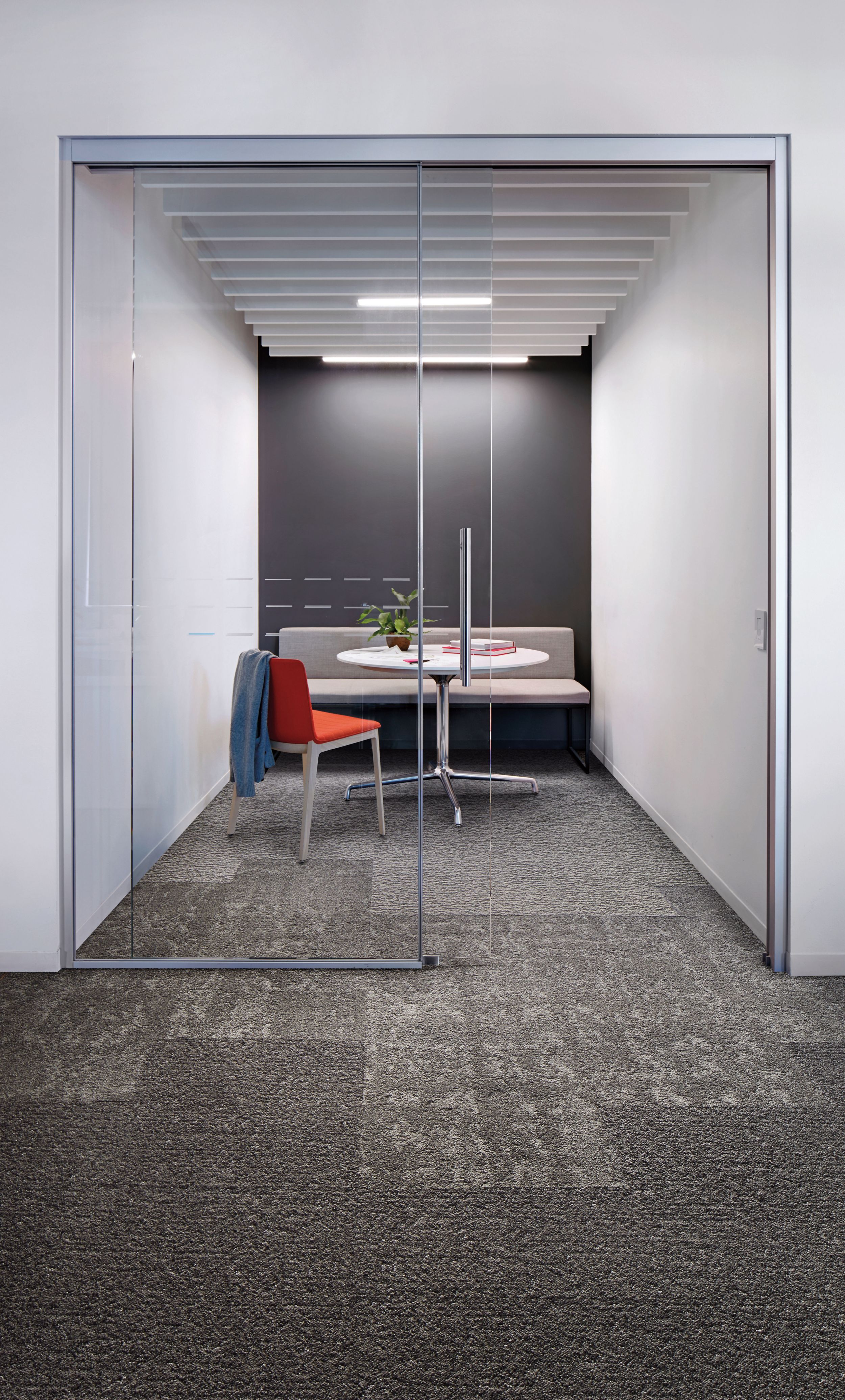 Interface Edge, Vessel and Riverwalk carpet tiles in focus room with red chair and plant on table numéro d’image 2