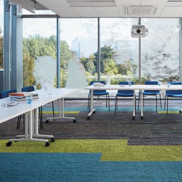 Interface Video Spectrum and Shaded Pigment carpet tile meeting room with large conference table