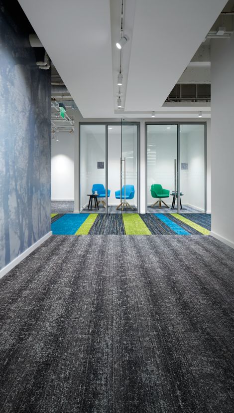 Interface Video Spectrum and Veiled Brushwork carpet tile in office common area showing focus rooms