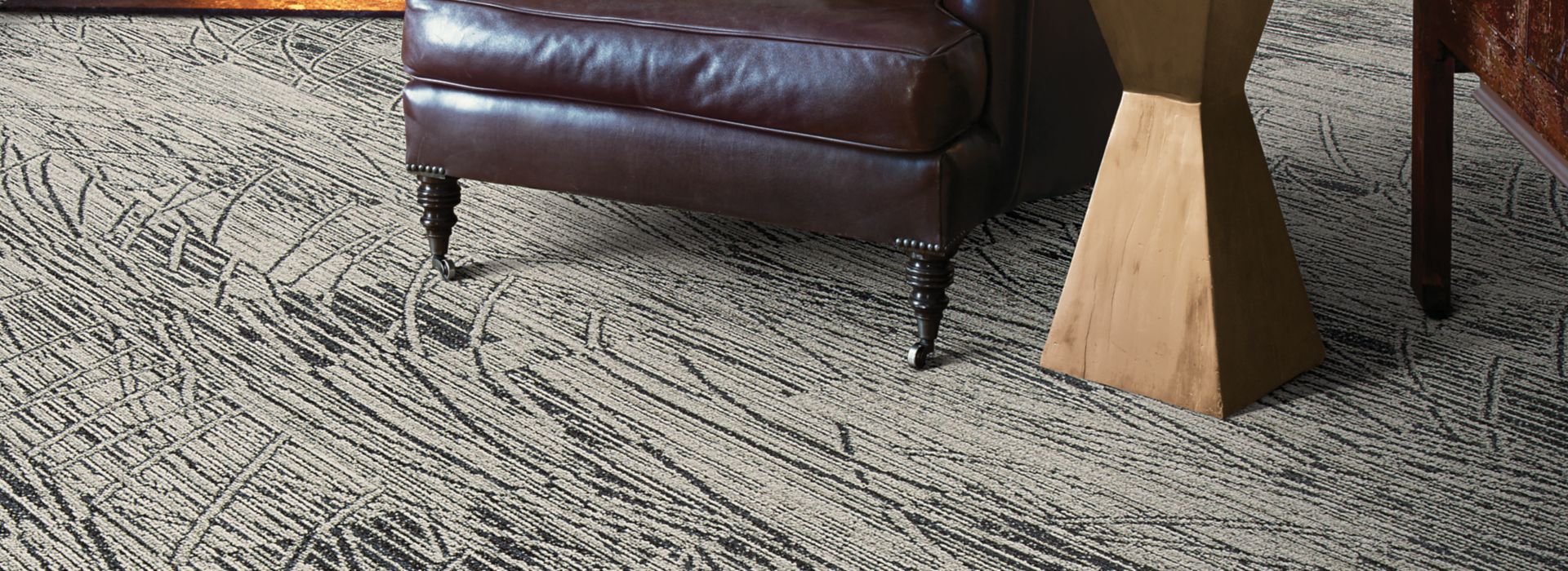 Interface WE152 plank carpet tile in sitting area with fireplace and large leather chair