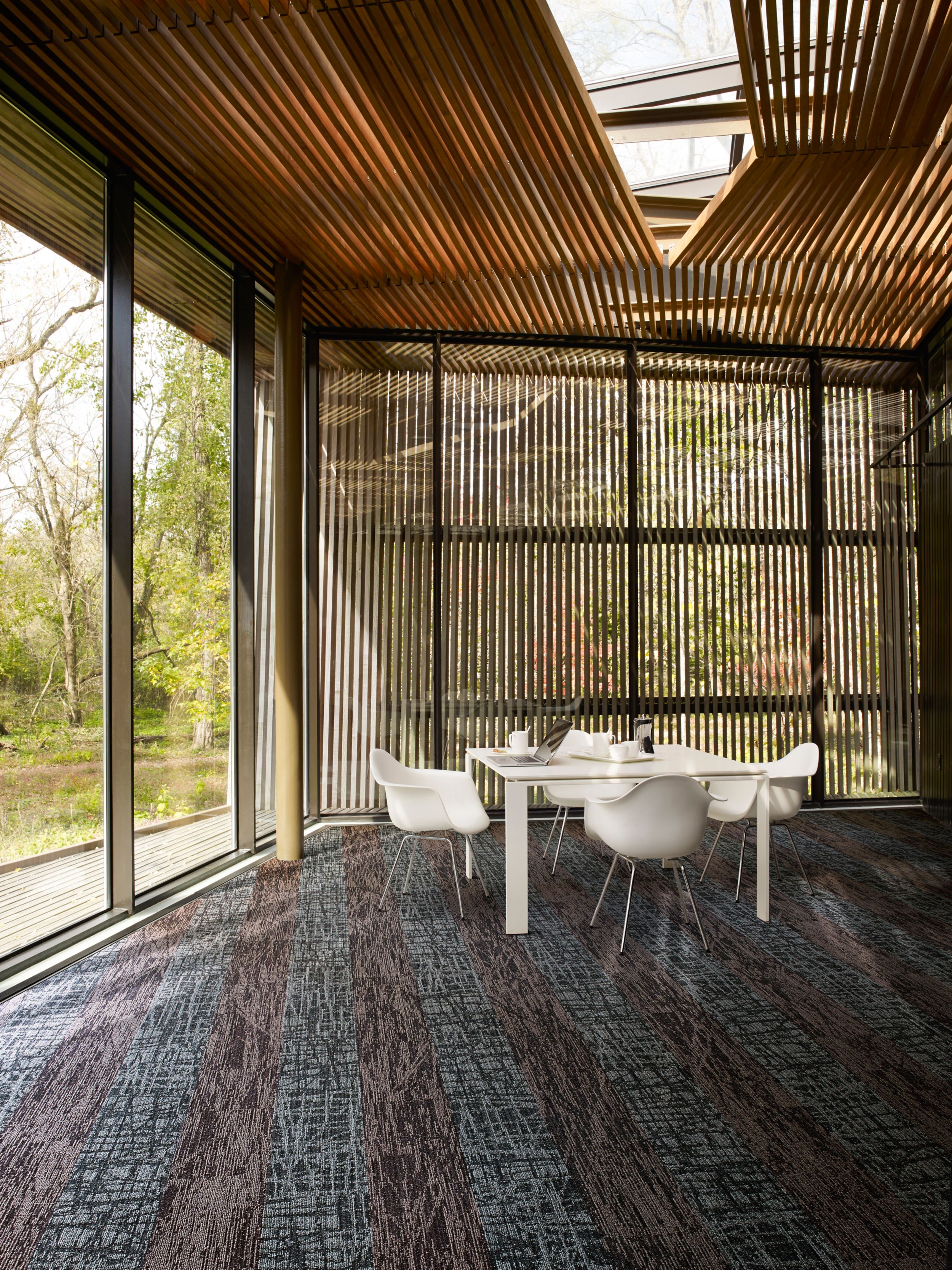 Interface WE153 and WE151 plank carpet tile in open area with wood ceiliing, glass walls and table and chairs image number 5