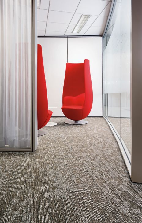Interface WE154 plank carpet tile in waiting area with large red statement chairs