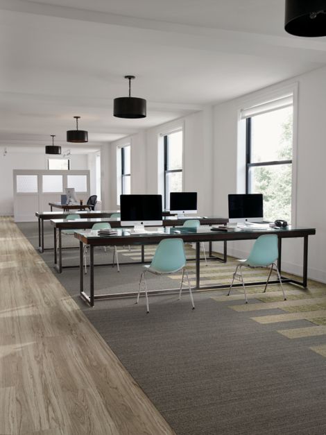Interface WW860 and WW895 plank carpet tile in open work area with teal chairs image number 12