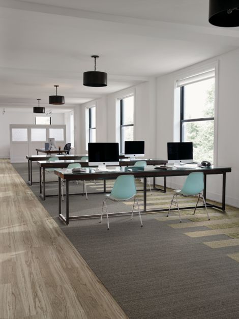 Interface WW860 and WW895 plank carpet tile in open work area with teal chairs image number 3