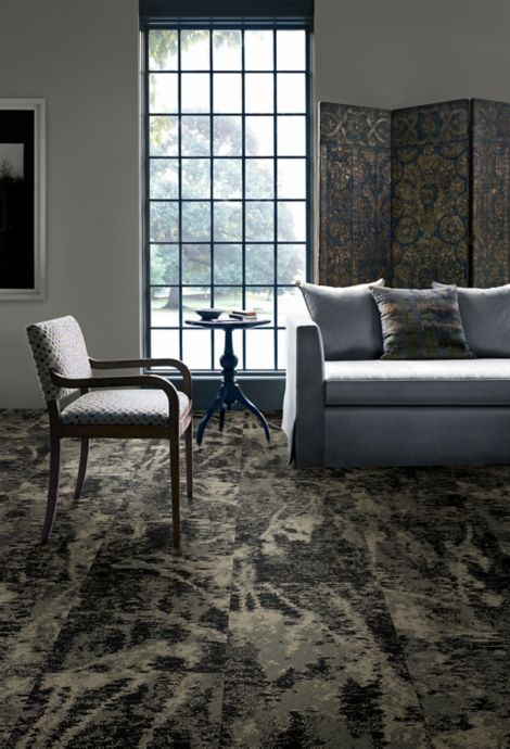 Interface Bouquet plank carpet tile in seating area with tall, multi-paned window