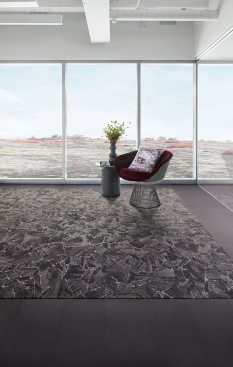 Interface Mile Rock carpet tile and Brushed Lines LVT in open room with chair and side table with plant image number 6
