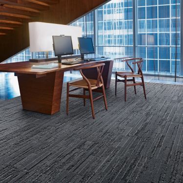 Interface CE173 plank carpet tile in office area with desk beneath stairwell