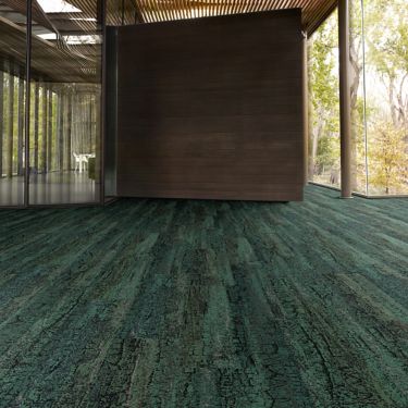 Interface Granite Peak plank carpet tile in open area with wood ceiling and wood accent wall image number 1