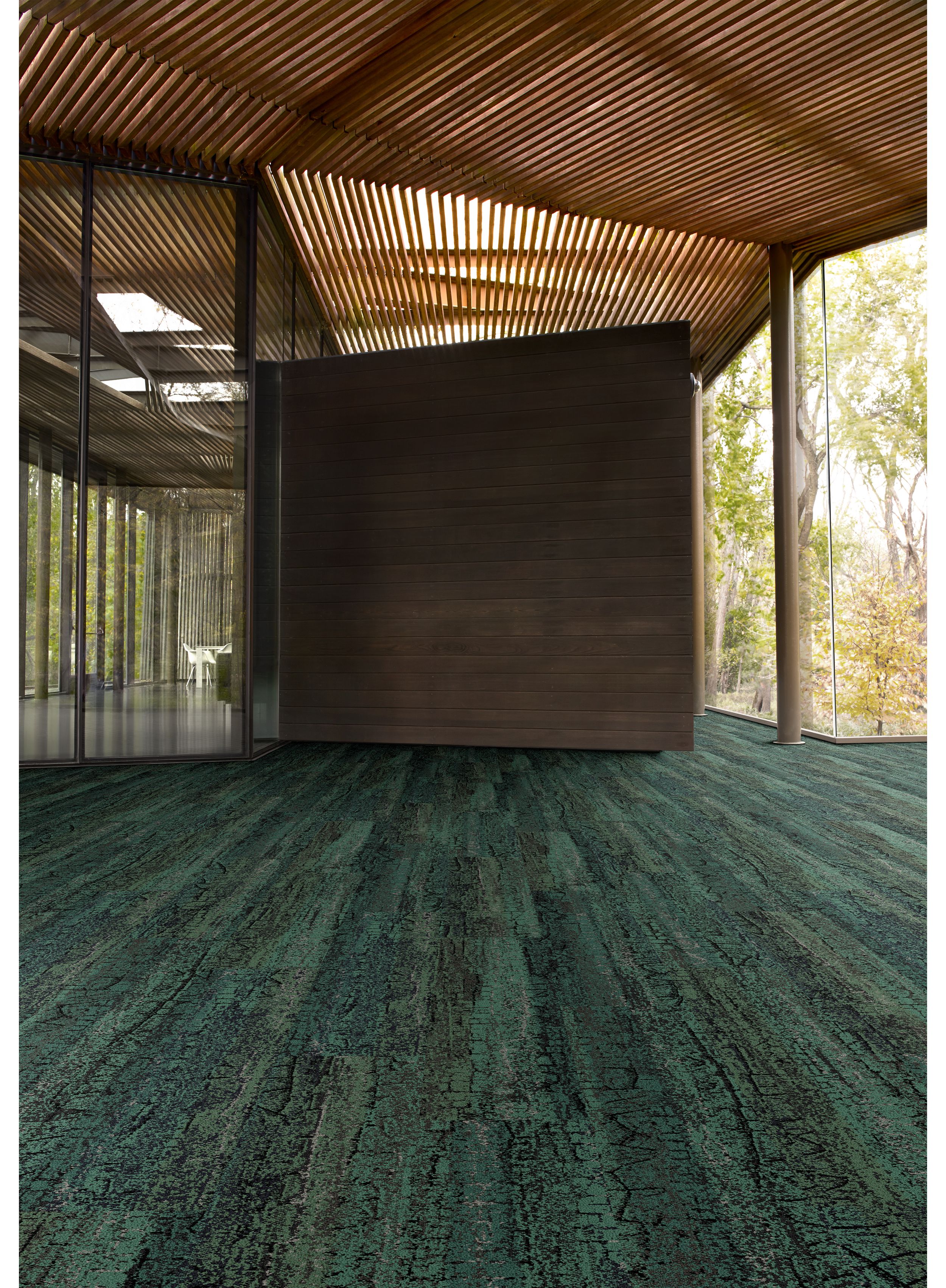 Interface Granite Peak plank carpet tile in open area with wood ceiling and wood accent wall image number 1