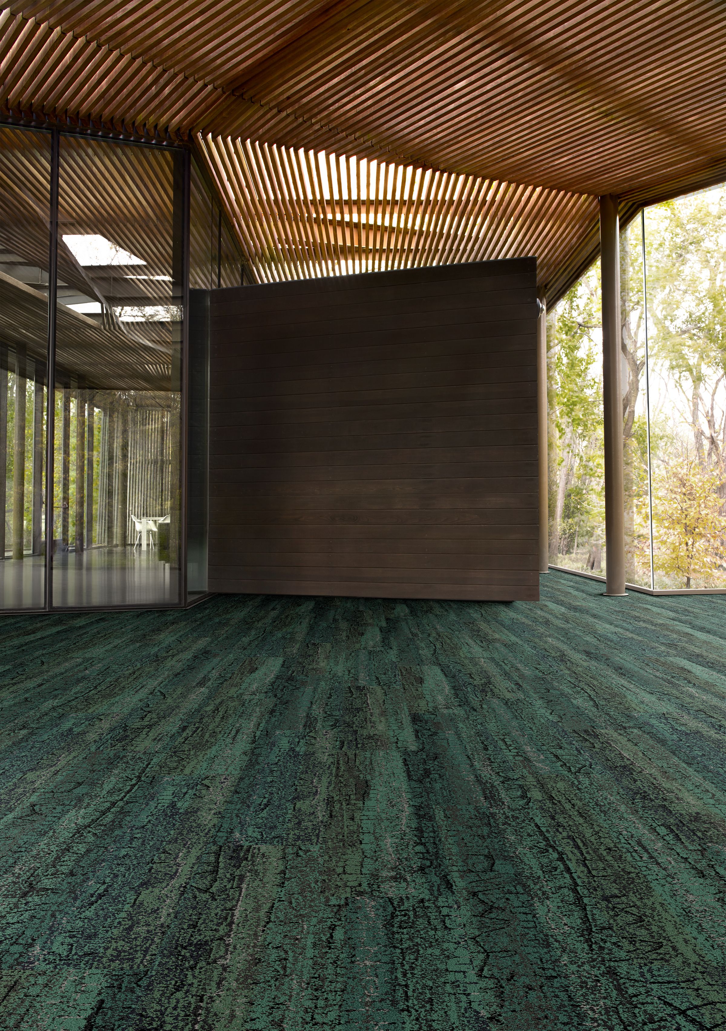 Interface Granite Peak plank carpet tile in open area with wood ceiling and wood accent wall image number 4