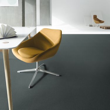 Interface Heuga 725 carpet tiles with white studio space in background and orange chairs image number 1