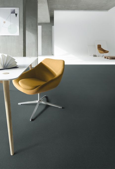Interface Heuga 725 carpet tiles with white studio space in background and orange chairs