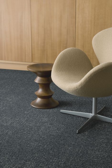 Detail of Interface Lighthearted carpet tile with chair and Eames stool