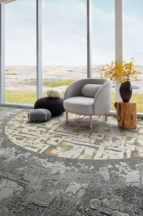 Interface Bridge Creek, Mountain Rock and Panola Mountain carpet tile in seating area with taupe chair and wood side table