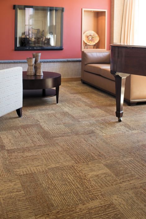 Interface Plain Weave carpet tile in lounge area with piano and seating