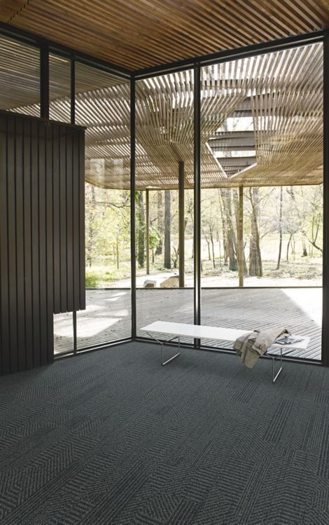 Interface Open Air 407 plank carpet tile in corner space with jacket draped over small white bench and wood slat ceiling imagen número 5