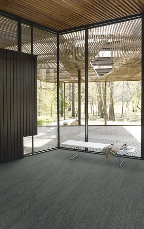 Interface Open Air 408 plank carpet tile in corner space with jacket draped over small white bench and wood slat ceiling imagen número 4