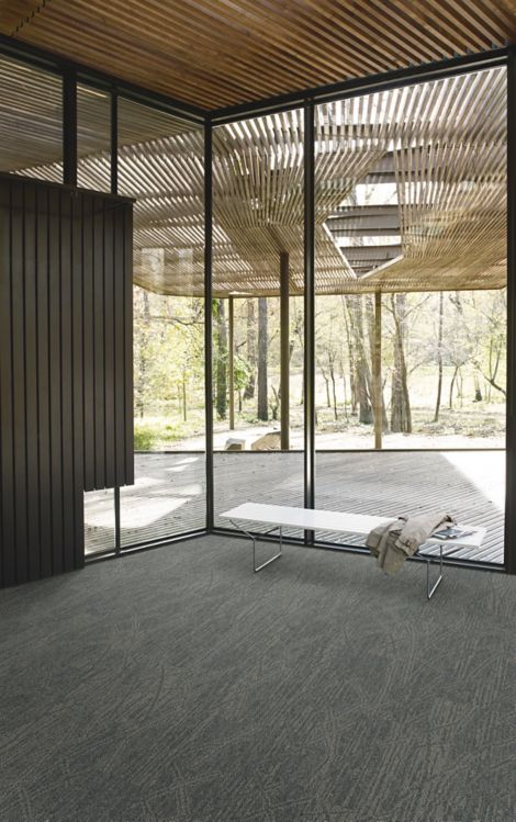 Interface Open Air 409 plank carpet tile in corner space with jacket draped over small white bench and wood slat ceiling image number 3