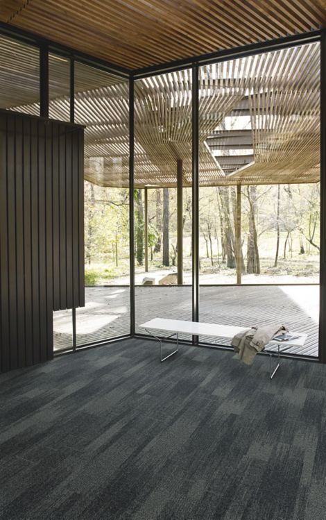 Interface Open Air 410 plank carpet tile in corner space with small white bench and wood slat ceiling