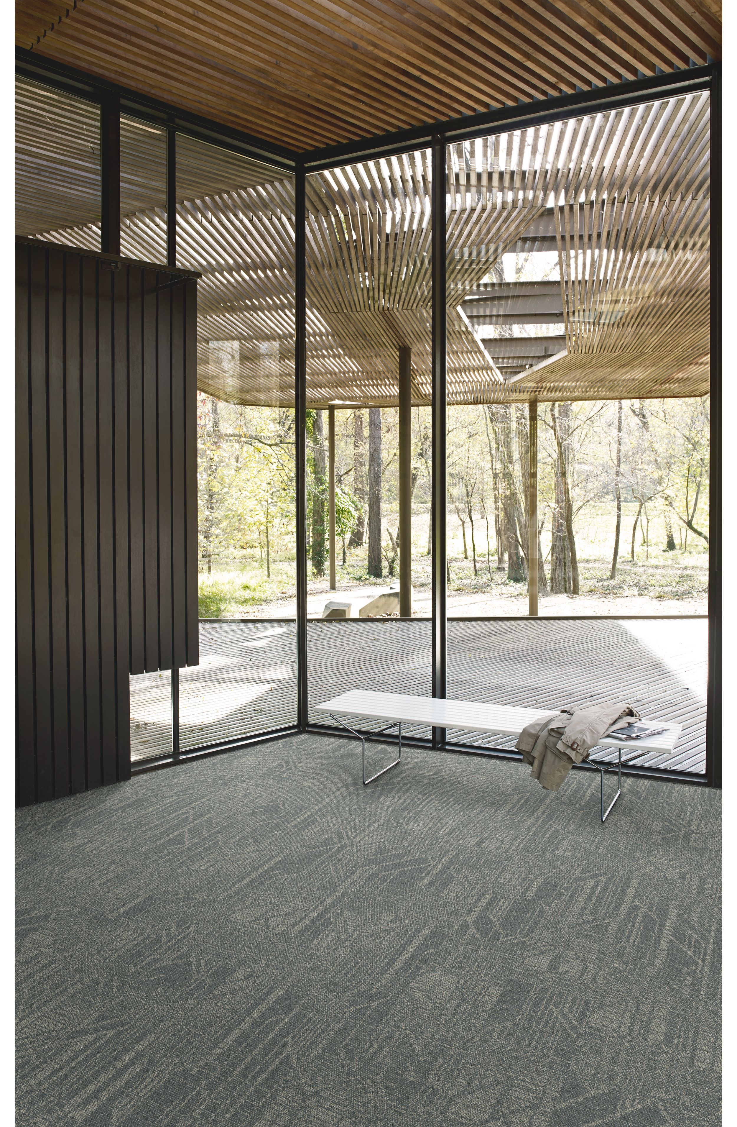 Interface Open Air 411 plank carpet tile in corner space with coat draped over small white bench image number 3