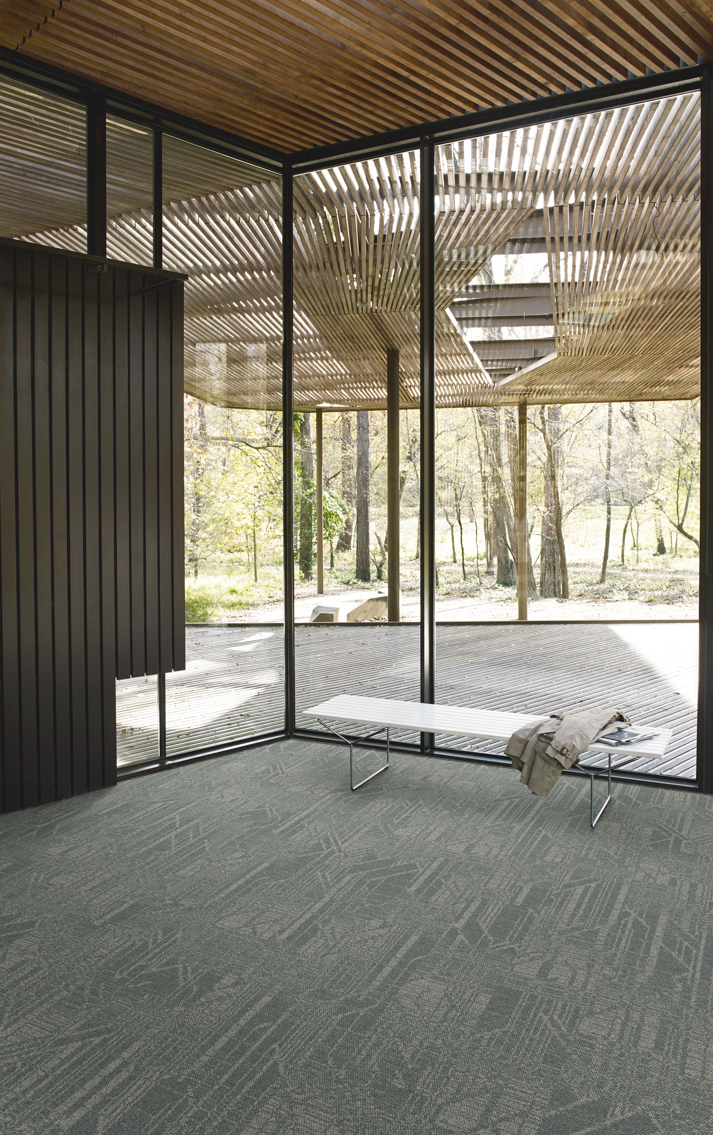 Interface Open Air 411 plank carpet tile in corner space with coat draped over small white bench image number 7