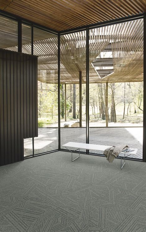 Interface Open Air 412 carpet tile in corner space with coat draped over small white bench and wood slat ceiling