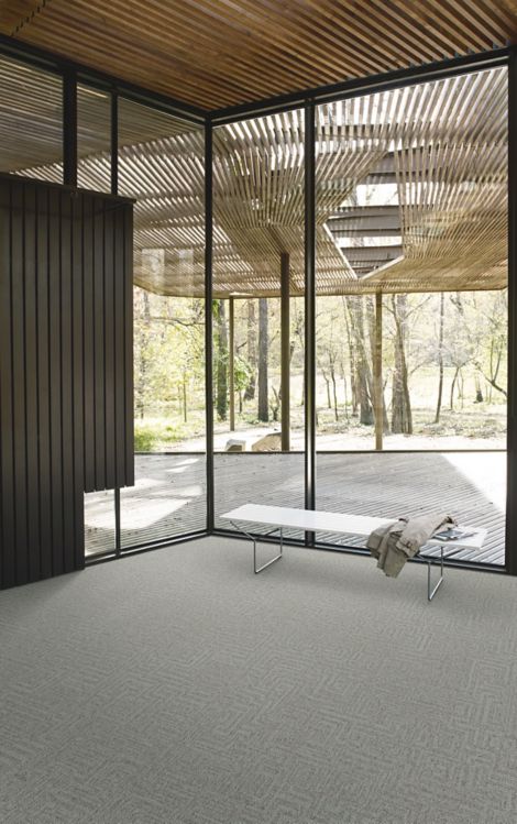 Interface Open Air 413 carpet tile in corner space with coat draped over small white bench and wood slat ceiling image number 3