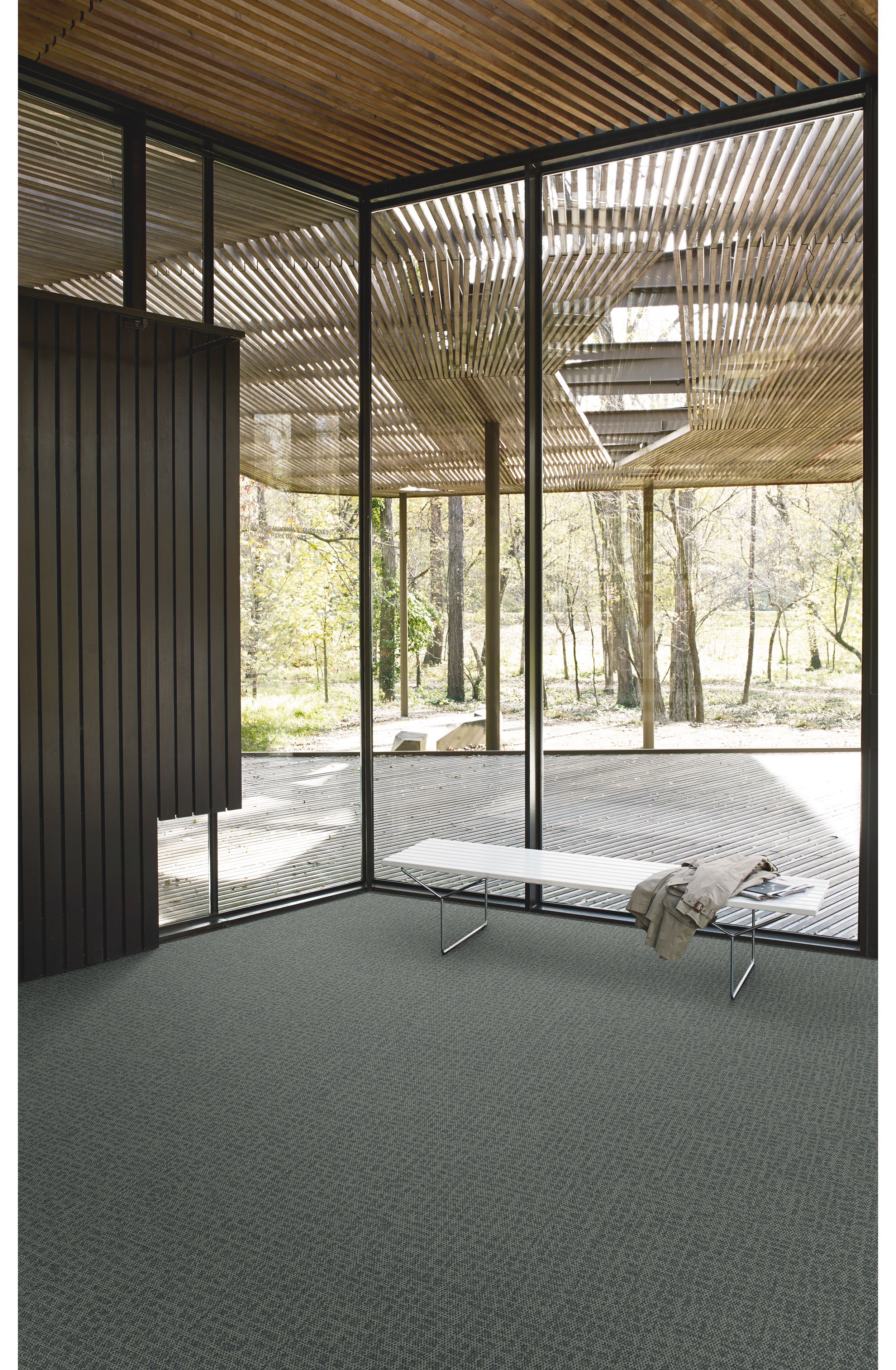 Interface Open Air 415 carpet tile in corner space with coat draped over small white bench and wooden slat ceiling image number 2